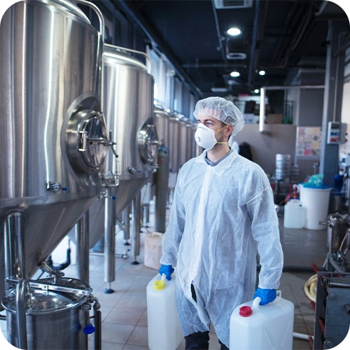 Opérateur portant des bidons - secteur de l'industrie agroalimentaire